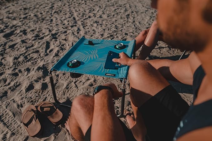 Neso Beach Table - Lightweight Portable and Foldable Table for Beach Camping and Outdoor Adventures - Stable Surface - with Cup Holder for Drinks and Phone Pockets - Aqua Fronds